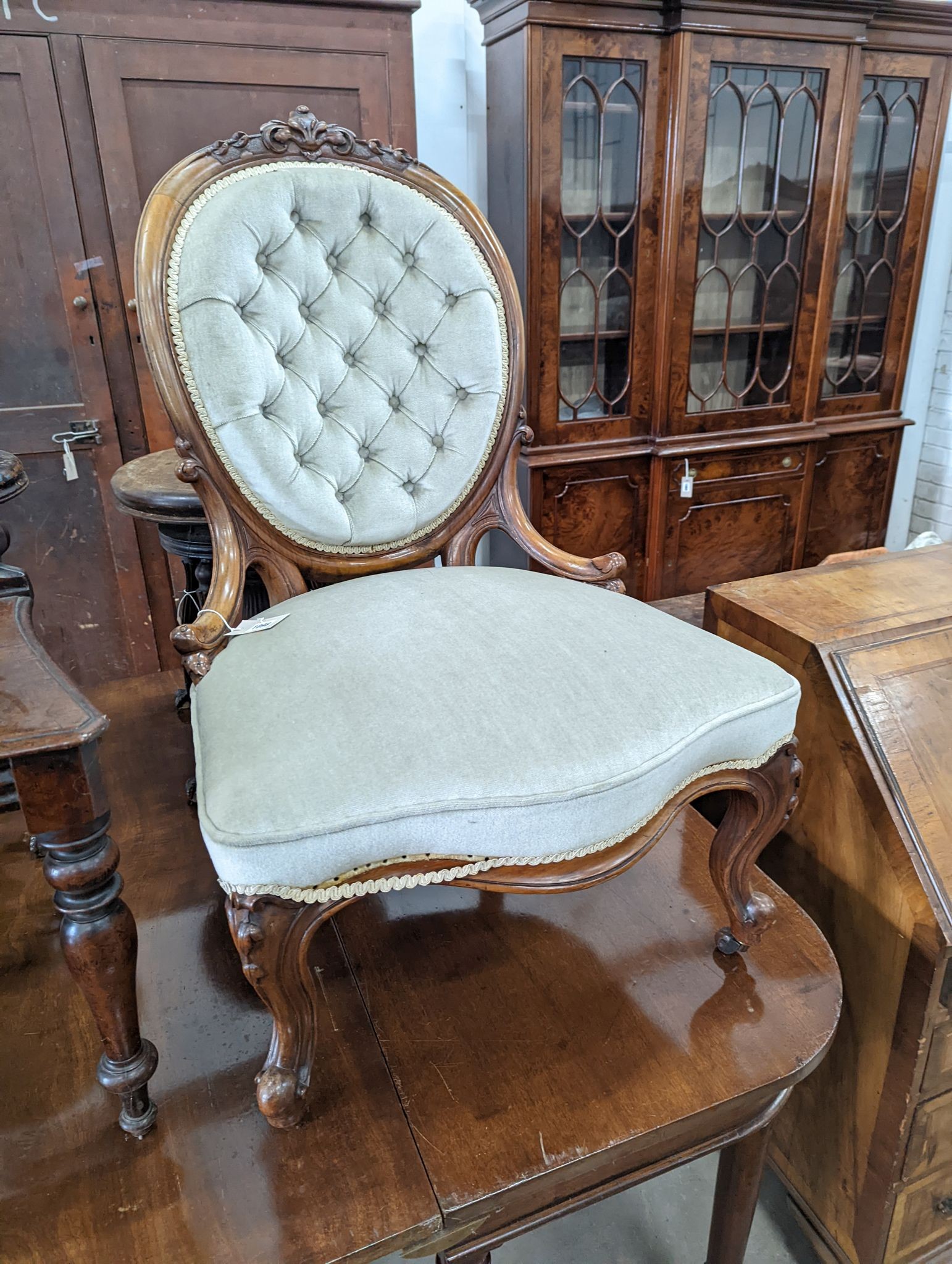 A Victorian walnut upholstered spoonback nursing chair